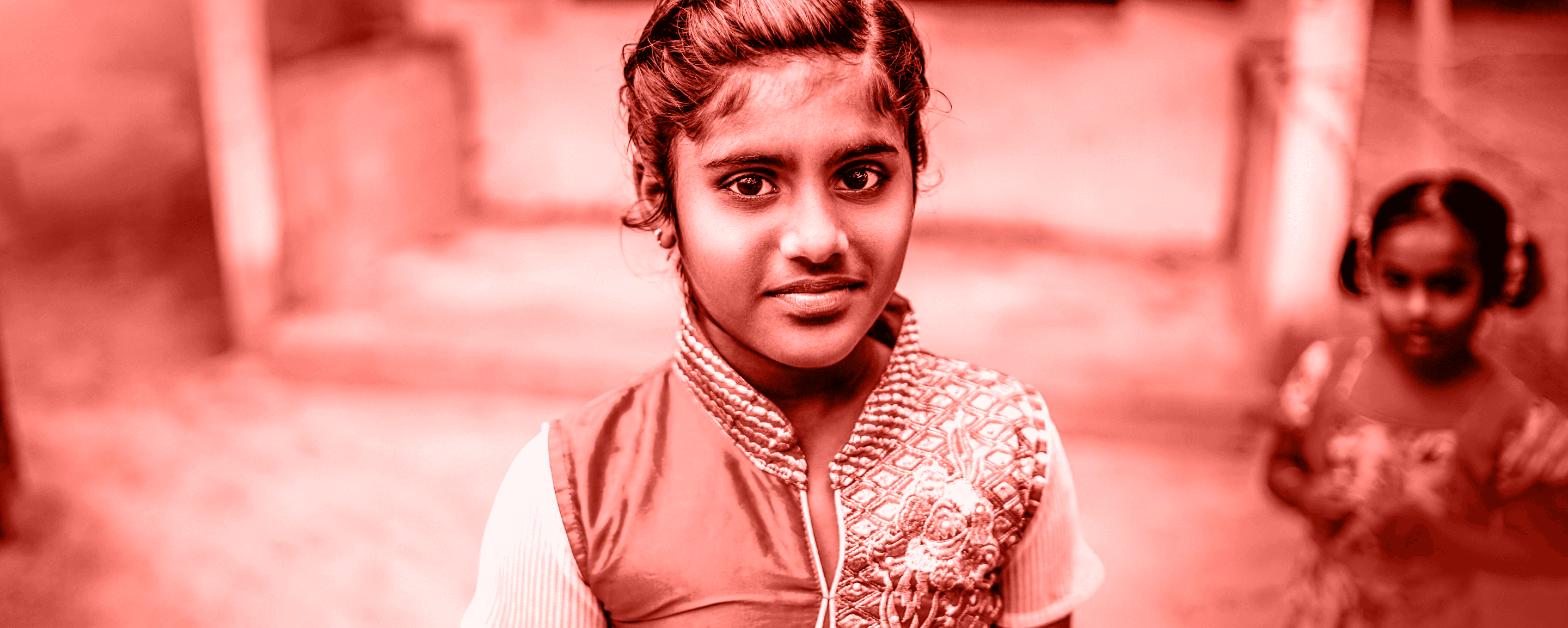 Two young Indian girls playing on the street